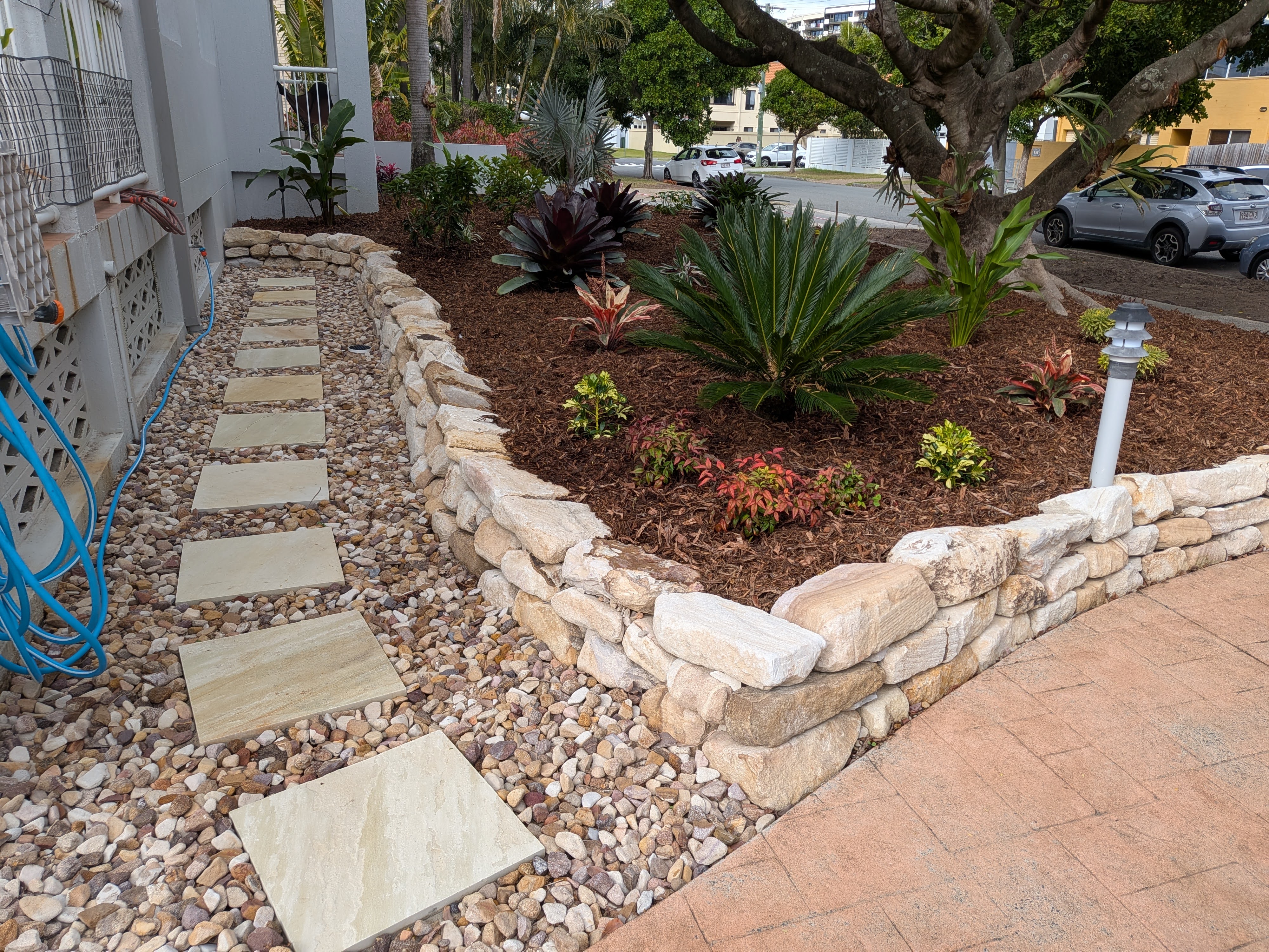 Completed garden with stone retaining wall and subtropical planting